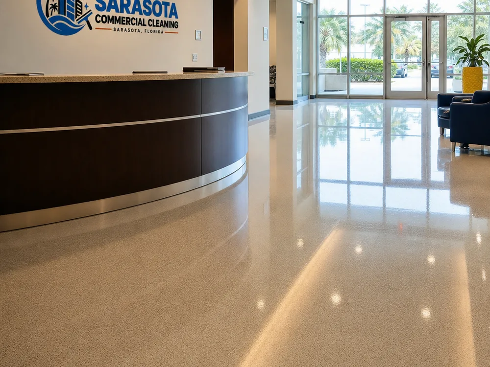 Freshly finished commercial lobby floor with an even gloss, clean baseboard edges, and reflections from overhead lighting